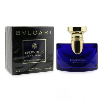 Deep blue glass bottle with a gold cap, featuring the label "Splendida Bvlgari Tubereuse Mystique," alongside a black box with gold accents, all showcasing an elegant design.