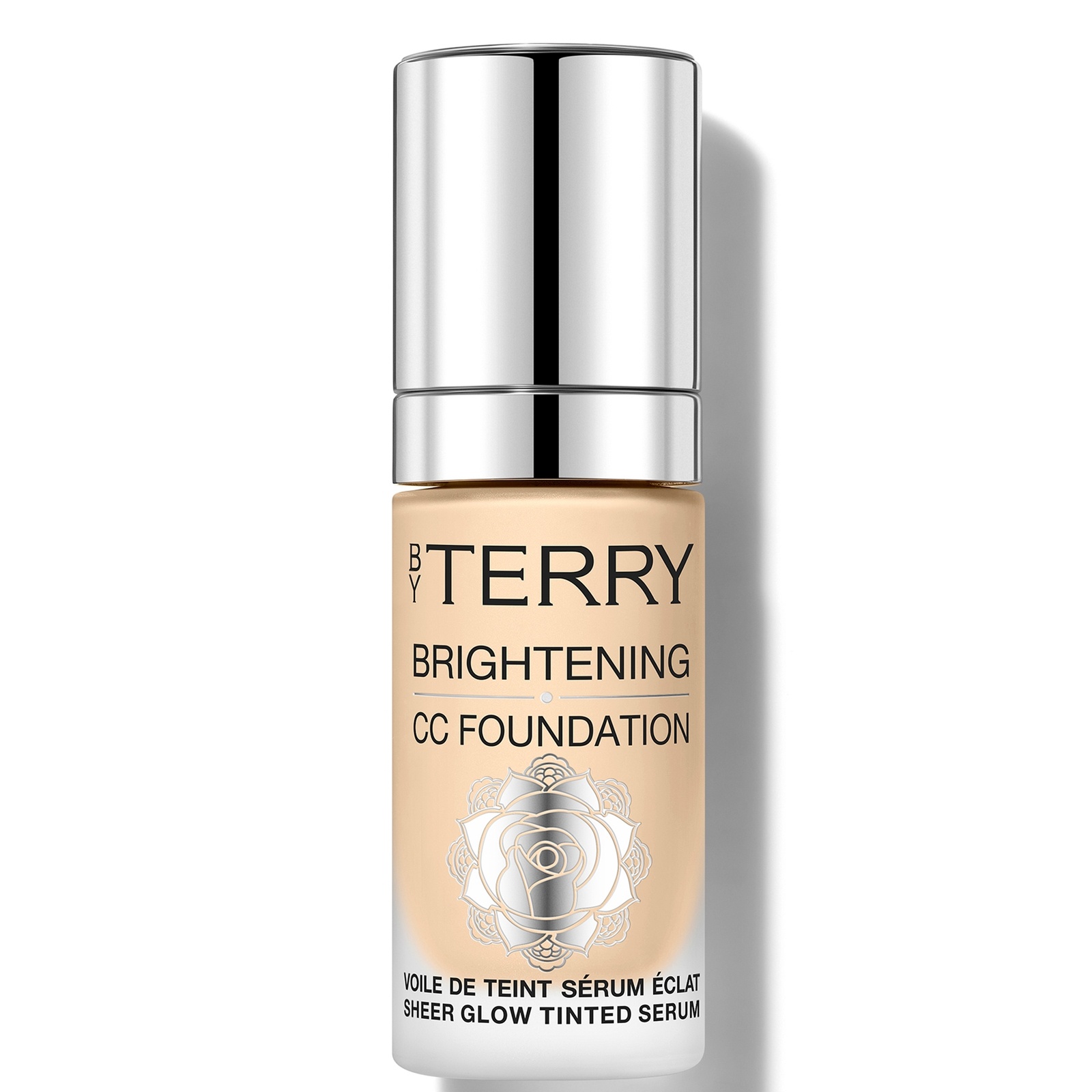 Light warm beige foundation in a sleek glass bottle with a silver pump, featuring a floral design and bold black text, labeled "BY TERRY Brightening CC Foundation 2W."
