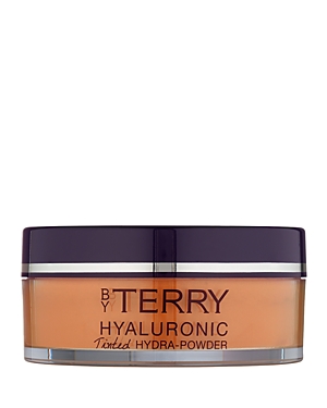 A round, translucent jar of By Terry Hyaluronic Tinted Hydra-Powder featuring a dark purple lid and a beige tinted powder inside, labeled with the brand and product name.