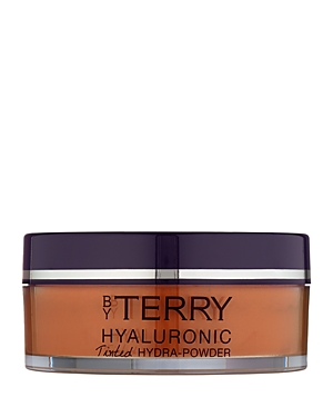 Translucent powder in a sleek, round container with a purple lid, featuring "BY TERRY" and "Hyaluronic Tinted Hydra-Powder" labels in elegant black text.