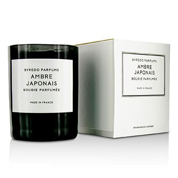 Black glass candle jar with a white label reading "Byredo Ambre Japonais," accompanied by a white box featuring the same label, both elegant and minimalist in design.