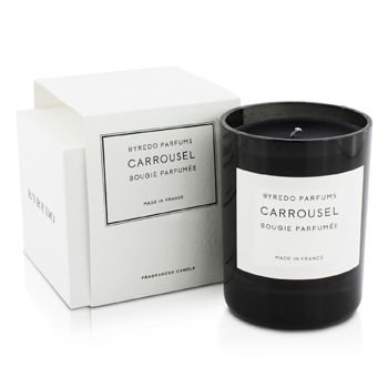 Black glass candle with a white label reading "Byredo Carrousel," placed beside a white box, showcasing a minimalist design and elegant branding.