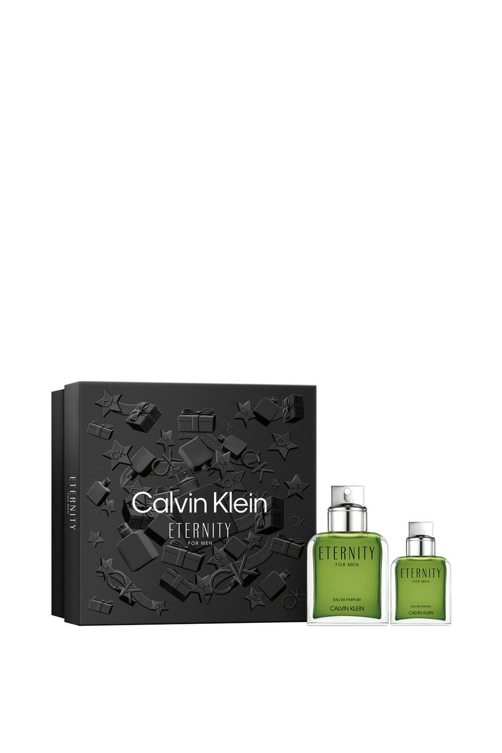 Calvin Klein Eternity for Men gift set featuring a 100ml green Eau De Parfum bottle and a smaller bottle, presented in a sleek black box with embossed star and gift designs.