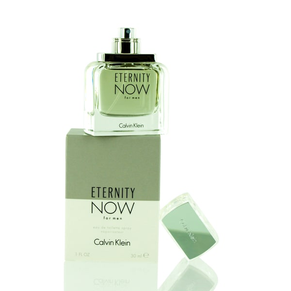 Clear glass bottle with a silver cap, featuring a square shape and the label "ETERNITY NOW for men" in bold lettering, placed on a grey and white box.