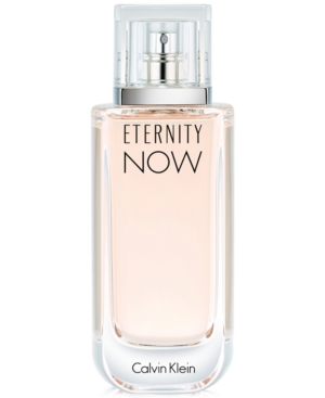 Clear glass bottle with a rectangular shape, featuring a silver spray nozzle and a light pink liquid, labeled "ETERNITY NOW" in bold black letters, by Calvin Klein.