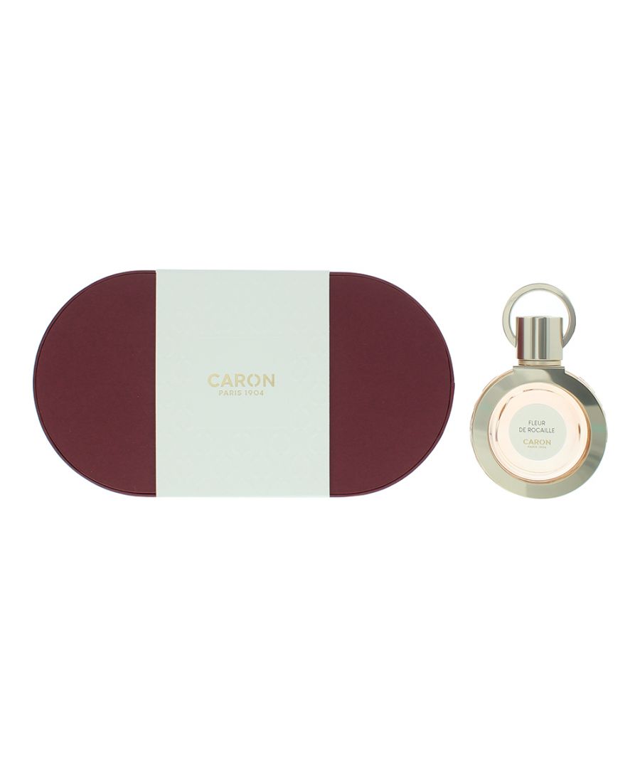 Elegant round bottle of Fleur De Rocaille Caron Eau De Parfum, 30ml, alongside a maroon and mint green box, featuring a gold accent and the brand name embossed on the packaging.