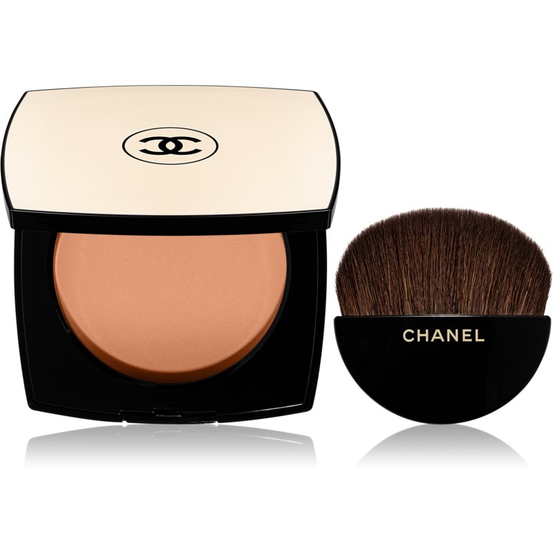 Chanel Les Beiges Healthy Glow Sheer Powder NO.60 features a round, beige compact with a black base, containing a warm-toned powder and a soft, rounded brush.