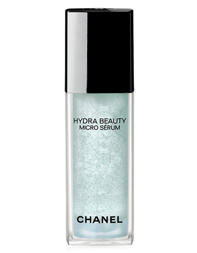 Clear glass bottle with a sleek design, featuring a black cap and a light blue serum inside, labeled "HYDRA BEAUTY MICRO SÉRUM" by CHANEL.