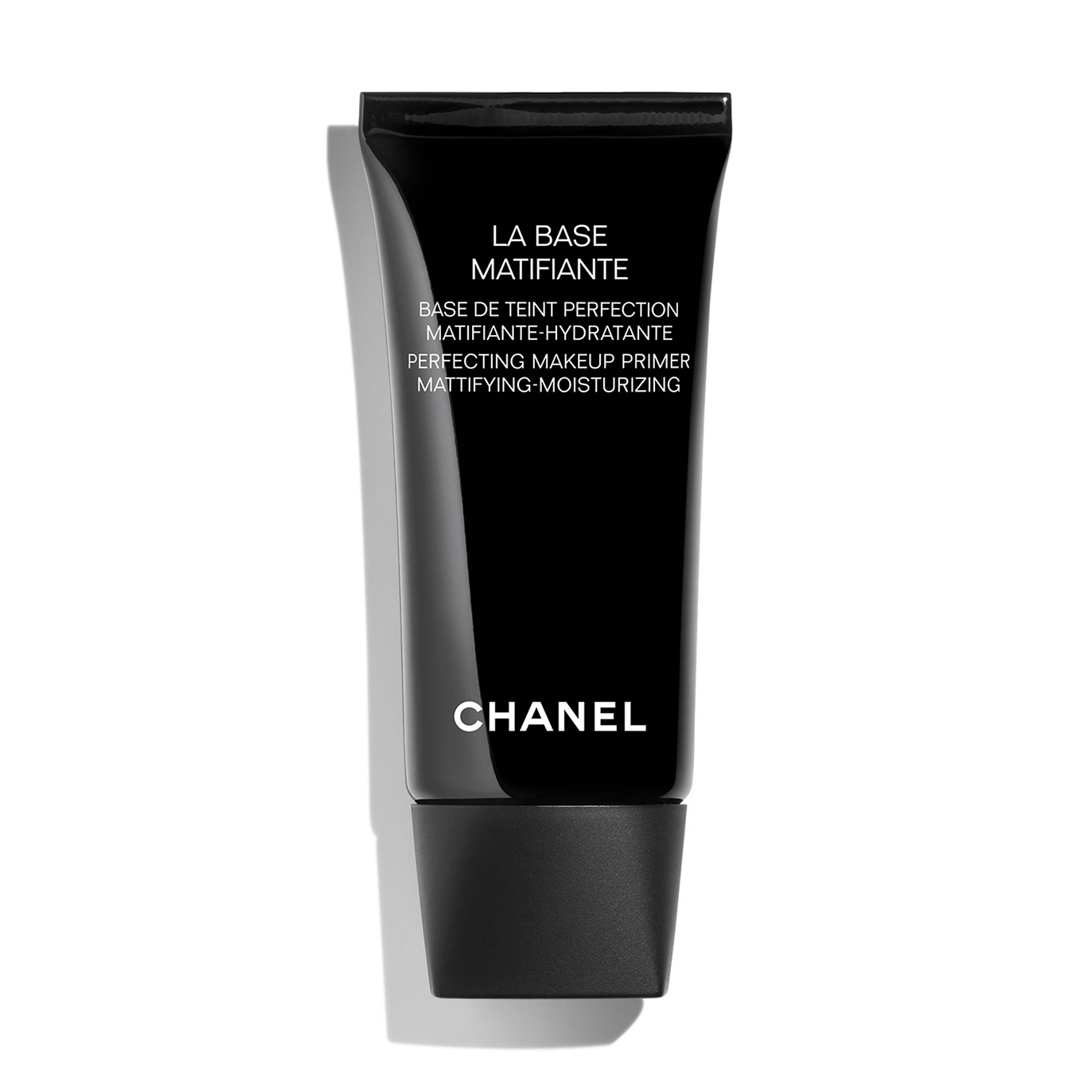 Black tube with a sleek design, labeled "LA BASE MATIFIANTE" in white, featuring a matte finish, and a black cap, indicating it's a mattifying and moisturizing makeup primer by Chanel.