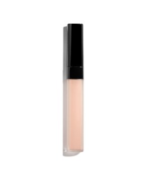 Chanel Color Corrector in shade B10, featuring a sleek, transparent tube with a black cap, designed to even out skin tone with a light peach hue.