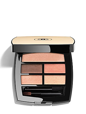 Chanel Les Beiges Warm Eye Shadow Palette features four shades in warm tones, housed in a sleek black compact with a gold lid, including a small applicator brush.