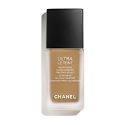 Beige foundation in a sleek glass bottle with a black cap, labeled "CHANEL ULTRA LE TEINT FLUIDE" for all-day comfort and a flawless finish.