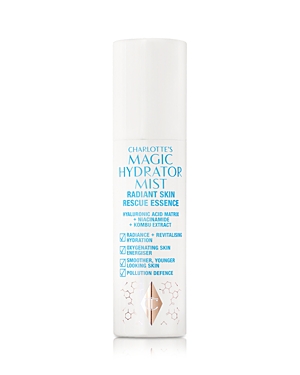 Charlotte's Magic Hydrator Mist in a sleek white bottle with blue text, featuring a pump spray top, highlighting hydrating and revitalizing skin benefits.