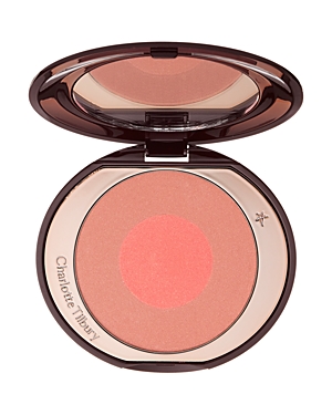 Charlotte Tilbury Cheek to Chic Blusher in Ecstasy features a glossy compact with a dual-tone blush, showcasing a soft peach outer ring and a vibrant coral center.