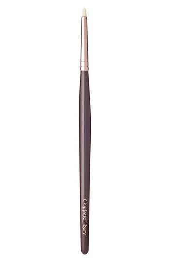 Charlotte Tilbury Eye Liner Brush features a sleek rose gold ferrule, a long, dark crimson handle, and a fine, tapered brush tip for precise application.