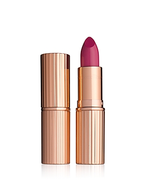 Charlotte Tilbury K.I.S.S.I.N.G Lipstick in Velvet Underground features a sleek rose gold tube with ribbed detailing and a vibrant fuchsia bullet.