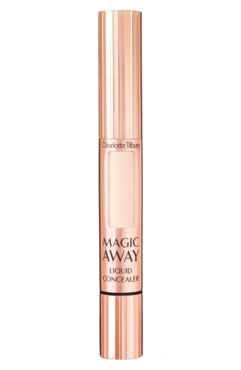 Charlotte Tilbury Magic Away Liquid Concealer in Beige features a sleek, rose gold tube with a sponge applicator and a creamy, lightweight formula for flawless coverage.