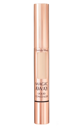 Charlotte Tilbury Magic Away Liquid Concealer in shade 4 features a sleek rose gold tube with a clear window, showcasing the light beige product inside and a sponge applicator tip.