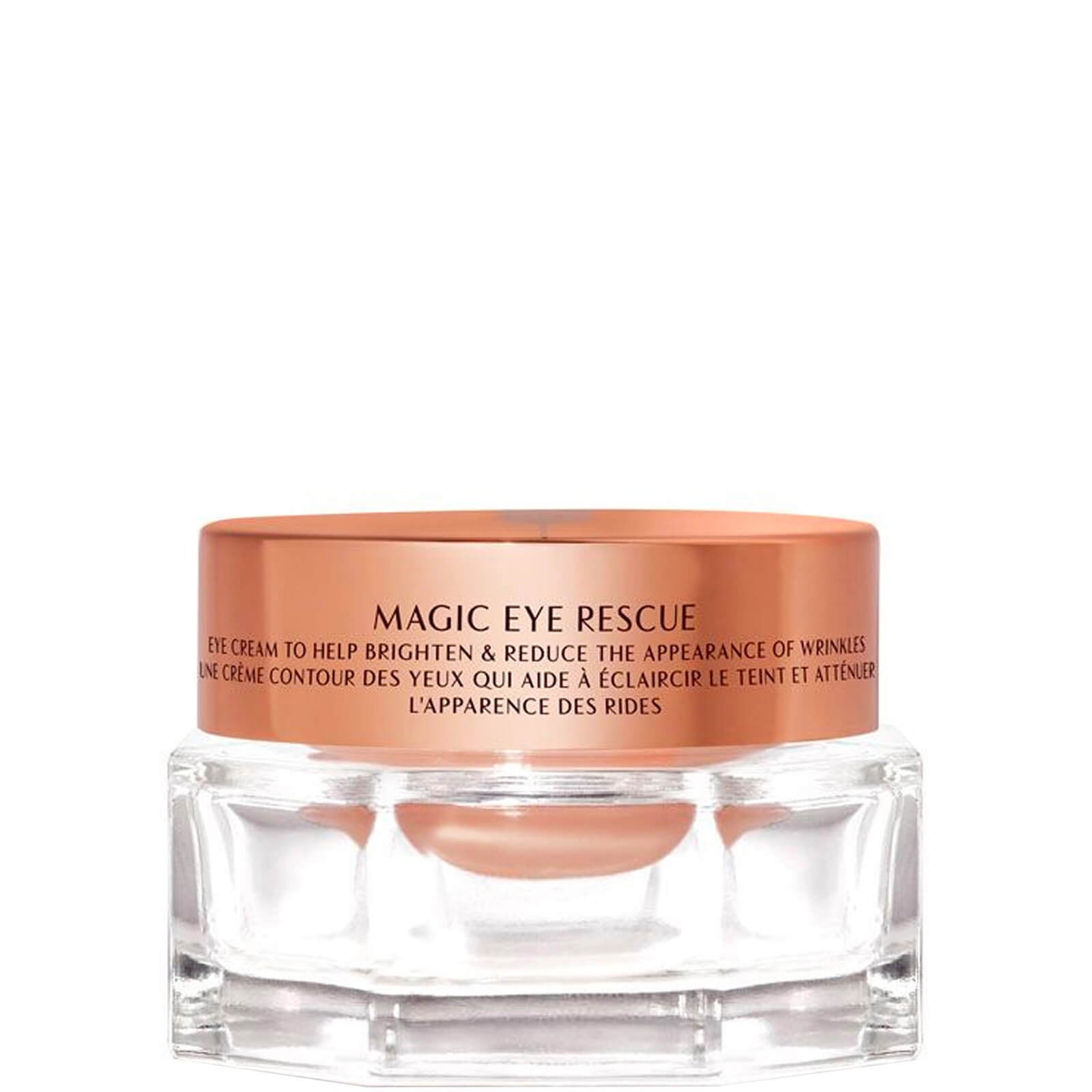 Charlotte's Magic Eye Cream in a clear glass jar with a rose gold lid, featuring text in both English and French, highlighting its anti-wrinkle benefits.