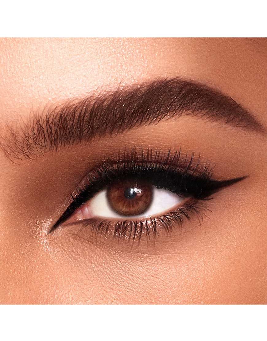 Close-up of a brown eye featuring a bold black winged eyeliner, showcasing the precise application and definition typical of Charlotte Tilbury's Feline Flick Volume 2.
