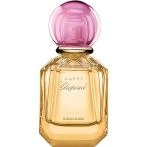 Clear glass bottle with a hexagonal base, featuring a golden liquid and a round pink and purple cap, labeled "HAPPY CHOPARD BIGARADIA" in elegant script.