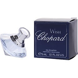 Clear glass mini spray bottle with a silver cap, featuring a unique shape, alongside a navy blue box labeled "Wish Chopard" in elegant white font.