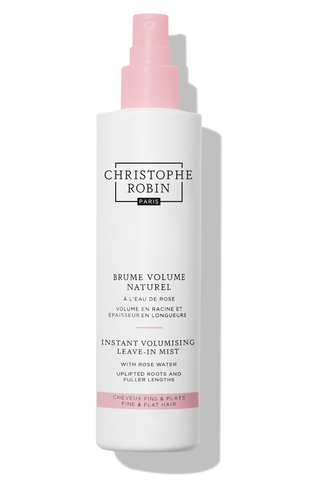 White spray bottle with a pink cap, labeled "Christophe Robin Instant Volumising Leave-in Mist with Rose Extract," featuring a minimalist design and 150ml capacity.