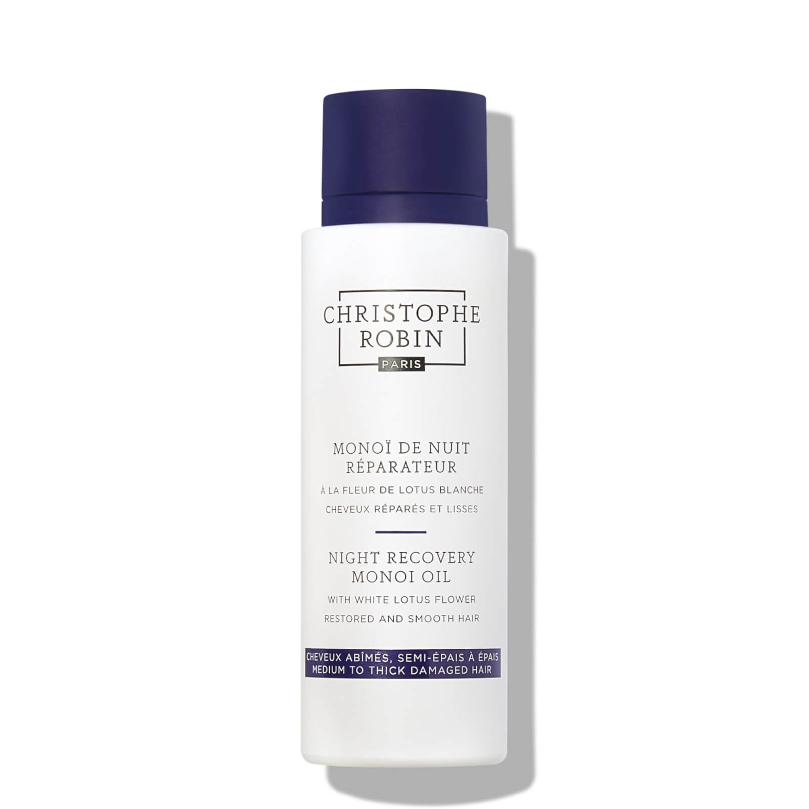 White bottle with a blue cap, labeled "Christophe Robin Night Recovery Monoï Oil" featuring white lotus flower, designed for restoring and smoothing hair, 92ml size.