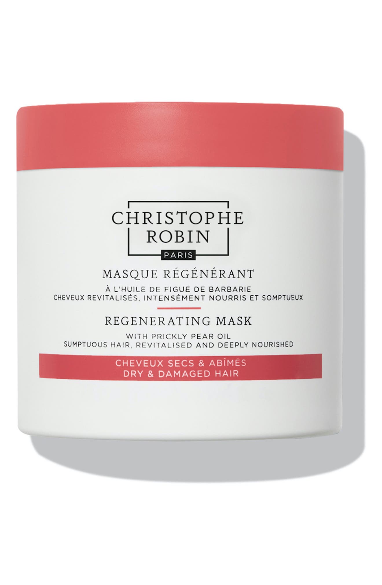 White jar with a pink lid, labeled "Christophe Robin Regenerating Mask with Prickly Pear Oil," designed for dry and damaged hair, featuring elegant typography.