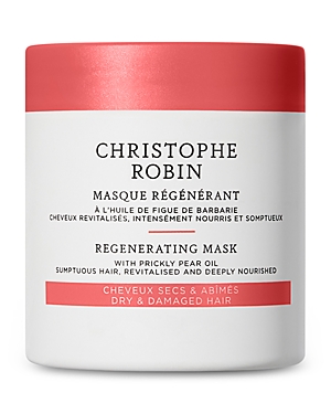 White cylindrical jar with a red lid, labeled "Christophe Robin Regenerating Mask" for dry and damaged hair, featuring prickly pear oil for nourishment.