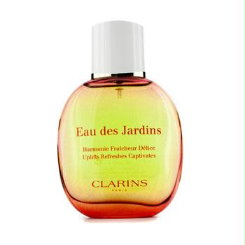 Glass bottle of Eau Des Jardins Treatment Fragrance Spray by Clarins, featuring a gradient from yellow to orange, with a gold cap and red text on the front.