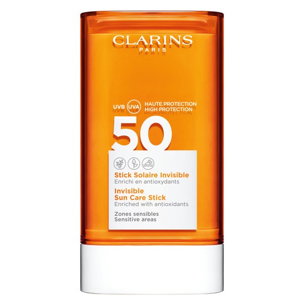 Orange cylindrical container with a white label, featuring "Clarins" and "SPF 50" prominently, designed for sun protection on sensitive areas, enriched with antioxidants.