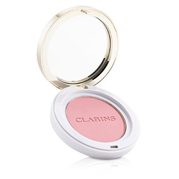 Round compact with a gold rim and clear lid, containing soft pink blush labeled "CLARINS," showcasing a smooth powder texture.