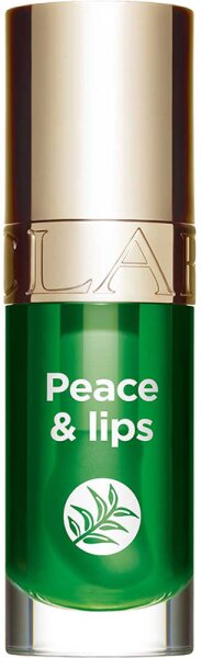 Clarins Lip Comfort Oil in a 7ml glass bottle, featuring a vibrant green hue, gold cap, and the text "Peace & lips" with a leaf graphic on the front.
