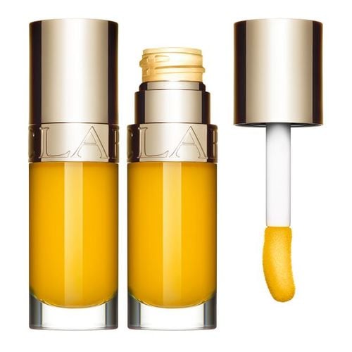 Clarins Lip Comfort Oil in a 7ml transparent tube, featuring a vibrant orange hue, a gold cap, and a soft applicator wand.