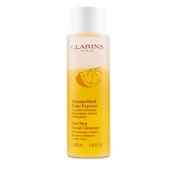 Yellow liquid cleanser in a clear plastic bottle with a white cap, labeled "Clarins One-Step Facial Cleanser" and featuring a lemon graphic, 6.8 oz size.