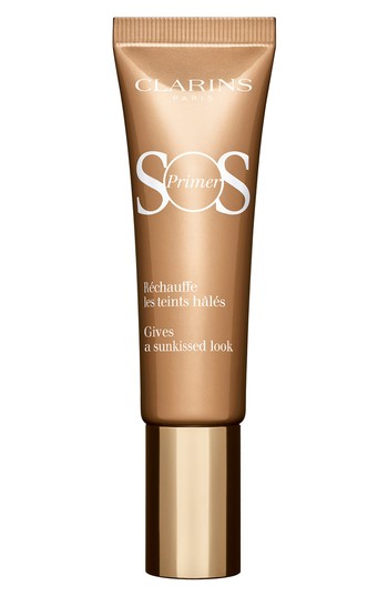Bronze-colored tube of Clarins SOS Primer 06, featuring a gold cap and white text, designed to give a sun-kissed look with a 30ml capacity.