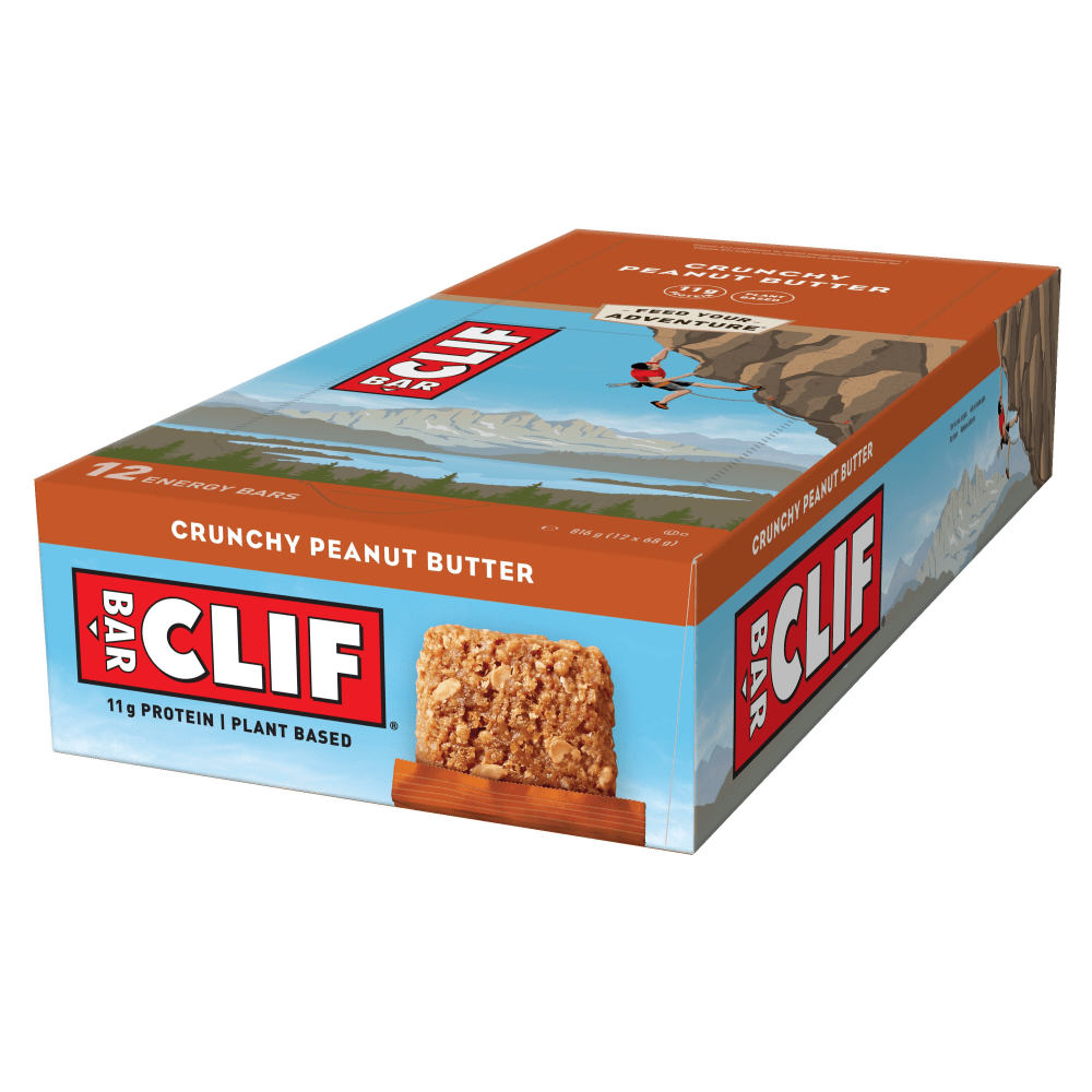 Clif Natural Energy Bar box in orange and blue, featuring a climber graphic, contains 12 Crunchy Peanut Butter bars, highlighting 11g protein and plant-based ingredients.