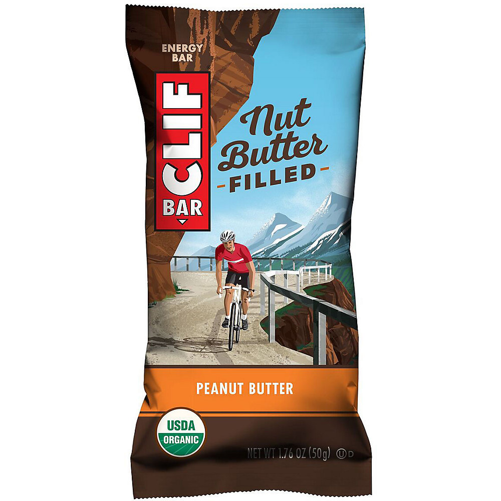Clif Nut Butter Filled Vegan Energy Bar in a colorful wrapper featuring a cyclist, with a peanut butter flavor and USDA Organic label, showcasing vibrant mountain scenery.