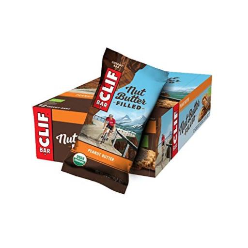 Clif Nut Butter Filled Vegan Energy Bars in a colorful box, featuring a peanut butter flavor, with one bar partially out of the box, showcasing its packaging design.