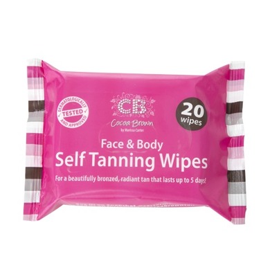 Bright pink packaging with black and white stripes, featuring "Cocoa Brown Face & Body Self Tanning Wipes" and "20 wipes" prominently displayed, designed for a radiant tan lasting up to 5 days.