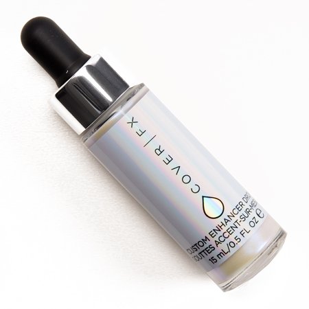 COVER FX Custom Enhancer Drops in a 15mL glass bottle with a dropper, featuring an iridescent finish and a sleek silver label with black text.