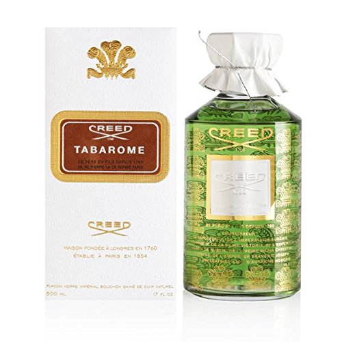 Green glass bottle with a gold label, featuring the name "Creed Tabarome" in elegant font, alongside a white box adorned with a gold crest and text.