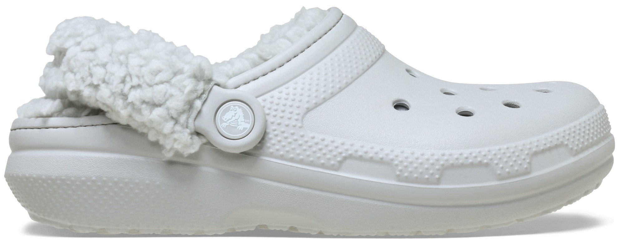 White fleece-lined Crocs clogs featuring a textured sole, ventilation holes, and a circular logo button, designed for unisex wear.