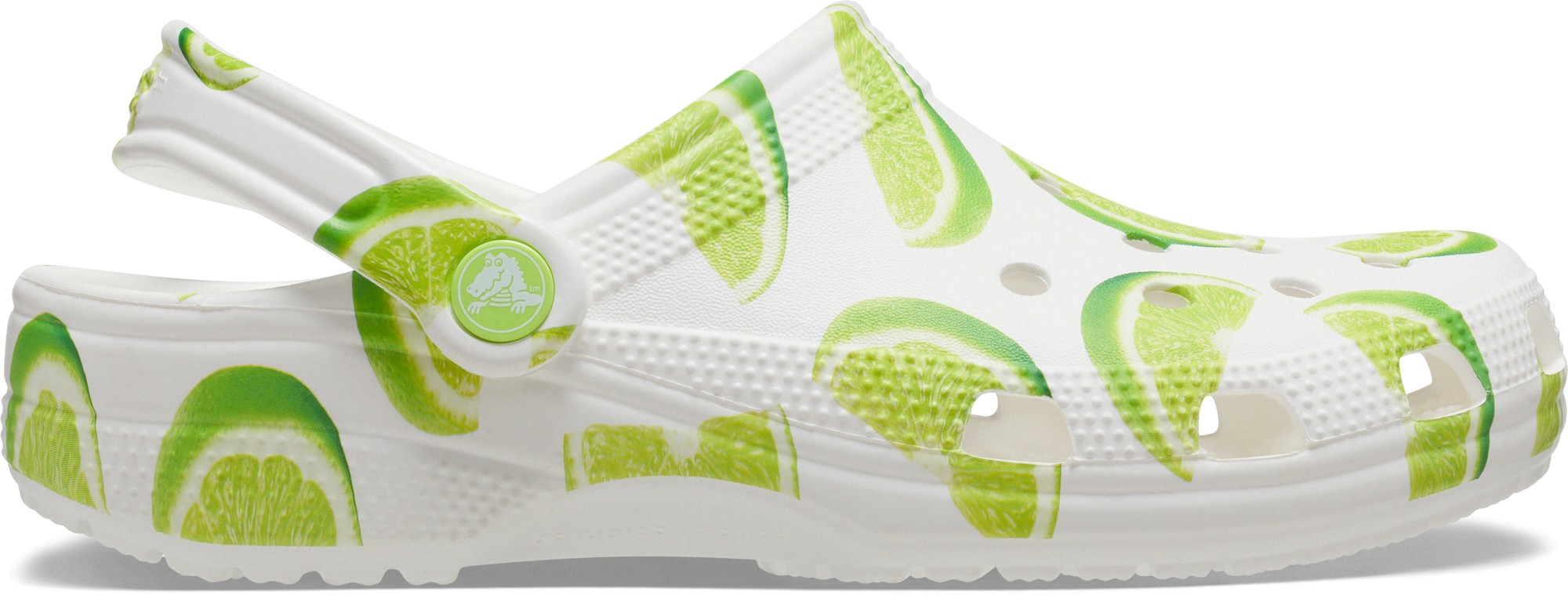 Lime green graphic clogs featuring a white base with lime slice patterns, made of lightweight Croslite material, with a back strap for a secure fit.