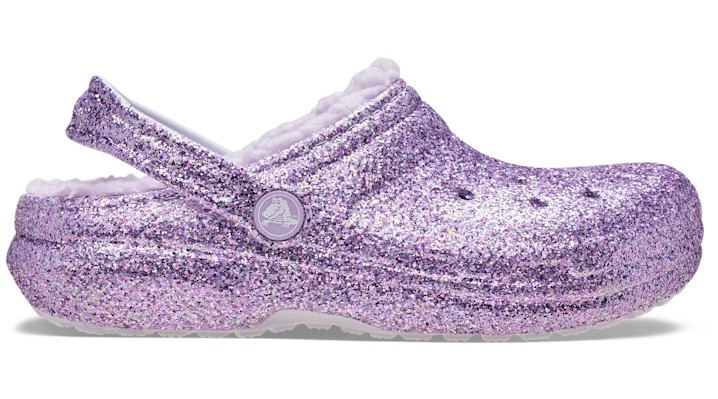 Purple glitter clog featuring a soft lined interior, adjustable back strap, and classic ventilation holes for breathability, designed for little to big kids.