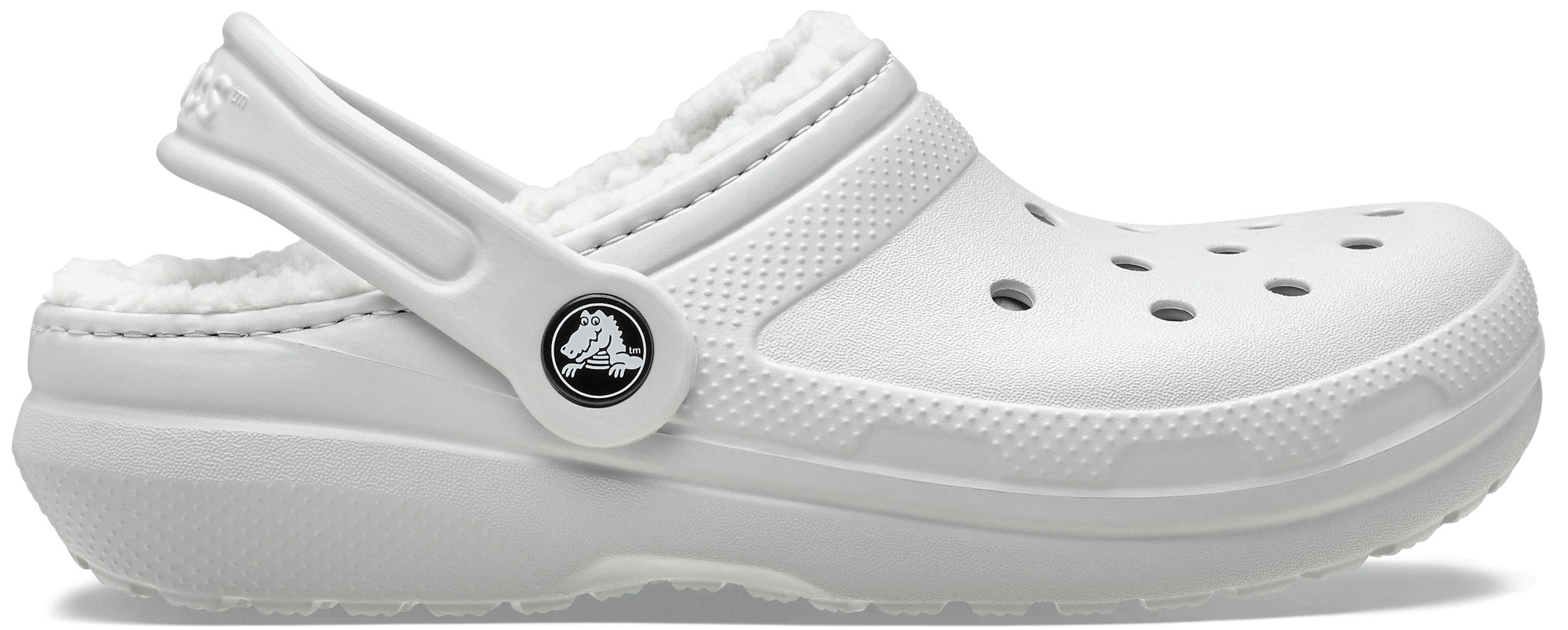 White thermoplastic clogs featuring a soft lined interior, ventilation holes, and a back strap for secure fit, designed for kids by Crocs.
