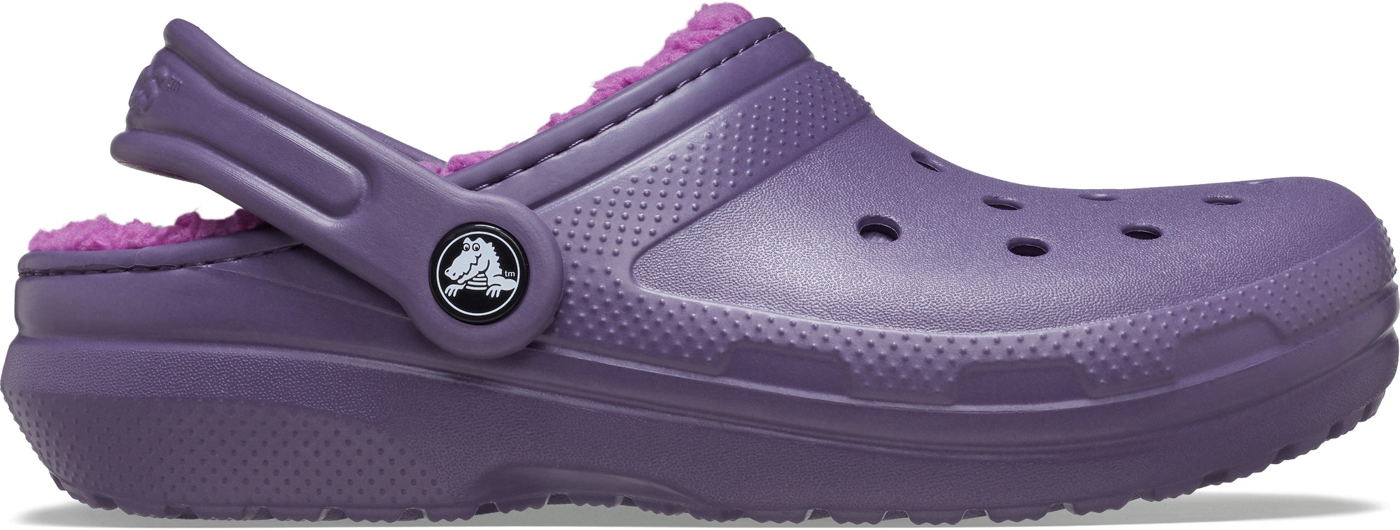Purple synthetic Crocs kids' clogs with a soft lined interior, featuring ventilation holes, a back strap, and a logo button on the side.