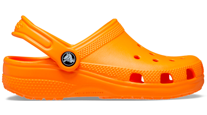Bright orange synthetic Crocs kids' classic clogs with ventilation holes, a back strap, and a textured sole, designed for toddlers in size 9 M.