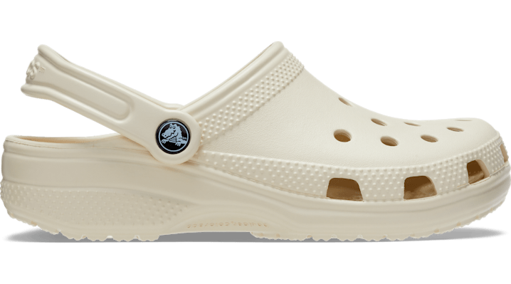 Beige Crocs clogs for women, size 4 UK, featuring a classic design with ventilation holes and a back strap for secure fit, made from lightweight, durable material.